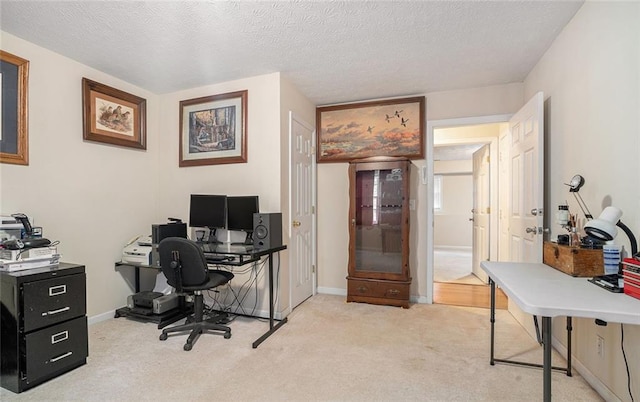 office space featuring a textured ceiling and light carpet