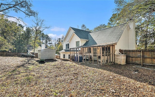 back of house with a shed