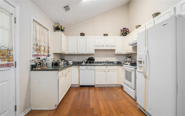 kitchen with white cabinetry, sink, high vaulted ceiling, hardwood / wood-style floors, and white appliances