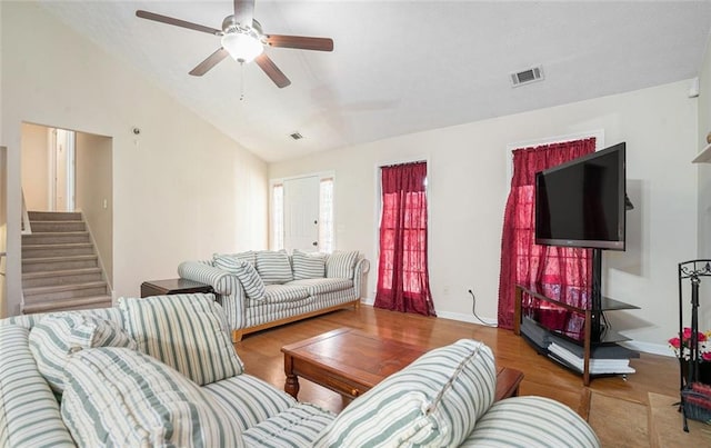 living room with ceiling fan, wood-type flooring, and lofted ceiling