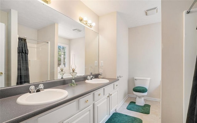 bathroom with vanity, curtained shower, and toilet