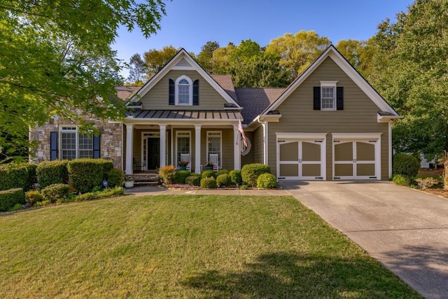 view of front of house with a front lawn, a porch, and a garage