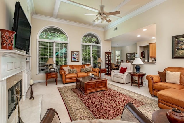 carpeted living room with ceiling fan, crown molding, a fireplace, and a high ceiling