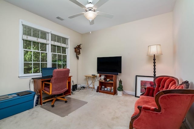 carpeted office featuring ceiling fan