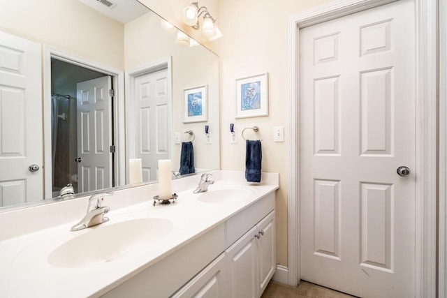 bathroom featuring dual bowl vanity