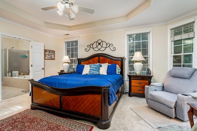 carpeted bedroom featuring a raised ceiling, ornamental molding, and ceiling fan