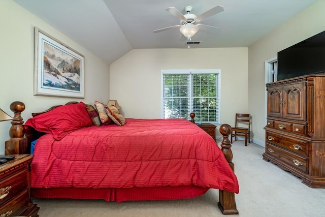 carpeted bedroom with ceiling fan and vaulted ceiling