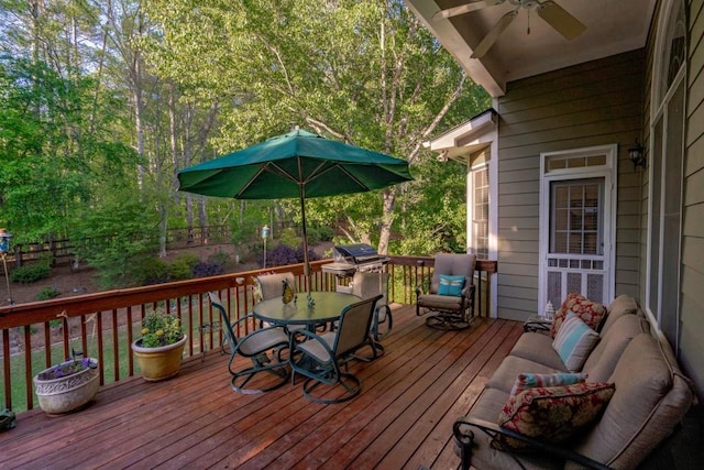 deck with grilling area and ceiling fan