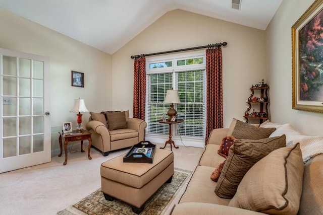 carpeted living room featuring vaulted ceiling