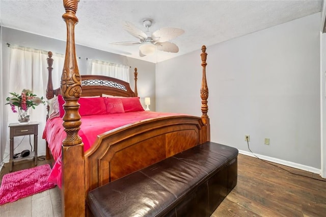 bedroom featuring a ceiling fan, baseboards, wood-type flooring, and a textured ceiling