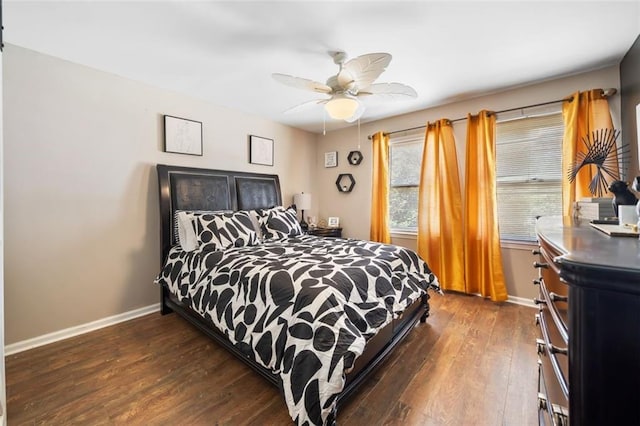 bedroom with ceiling fan, baseboards, and dark wood-style flooring