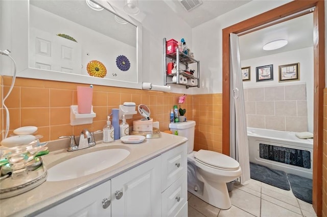 bathroom with vanity, visible vents, tile patterned flooring, toilet, and a bathtub