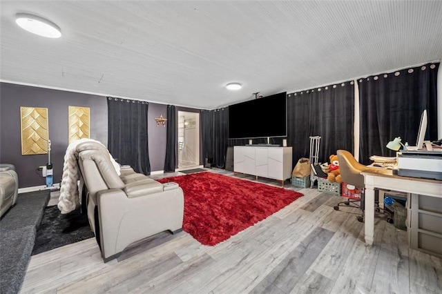 living room with baseboards and wood finished floors