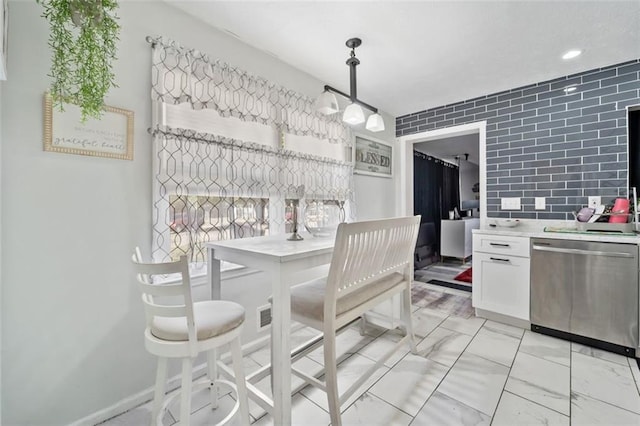 dining area with baseboards and marble finish floor