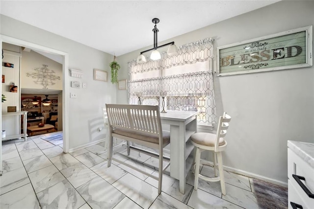 dining space with baseboards and marble finish floor