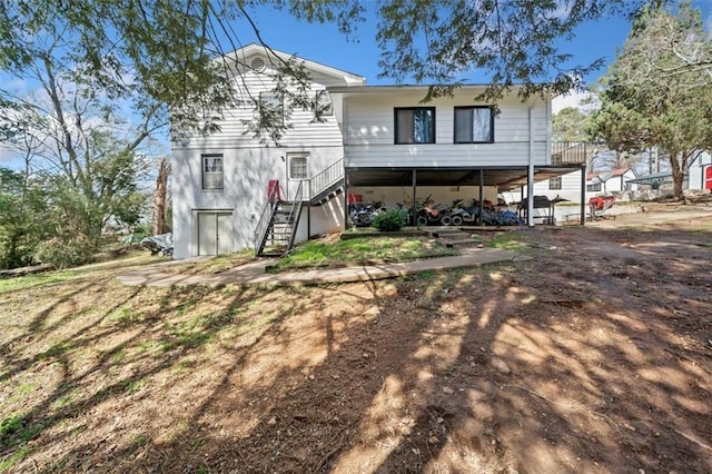 back of house featuring stairway