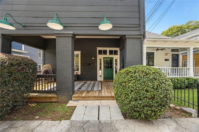 66 Howell St NE, Atlanta, GA 30312 - doorway to property with covered porch, a ceiling fan, and brick siding