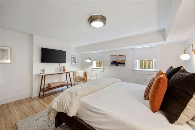 66 Howell St NE, Atlanta, GA 30312 - bedroom with wood finished floors, a textured ceiling, and baseboards