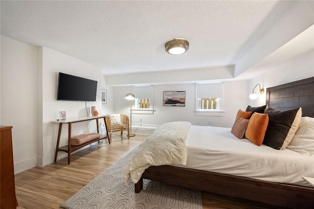66 Howell St NE, Atlanta, GA 30312 - bedroom featuring a textured ceiling, wood finished floors, and baseboards
