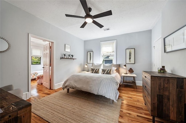 66 Howell St NE, Atlanta, GA 30312 - bedroom featuring light wood-style flooring, a textured ceiling, baseboards, and a ceiling fan