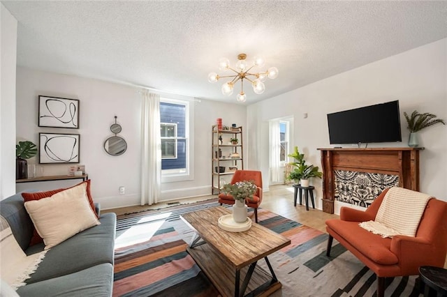 66 Howell St NE, Atlanta, GA 30312 - living area featuring a chandelier, a textured ceiling, wood finished floors, and baseboards
