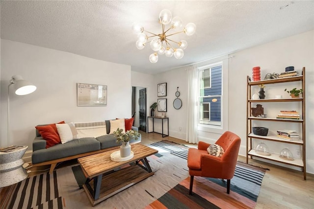 66 Howell St NE, Atlanta, GA 30312 - living area with light wood-style floors, a chandelier, a textured ceiling, and baseboards