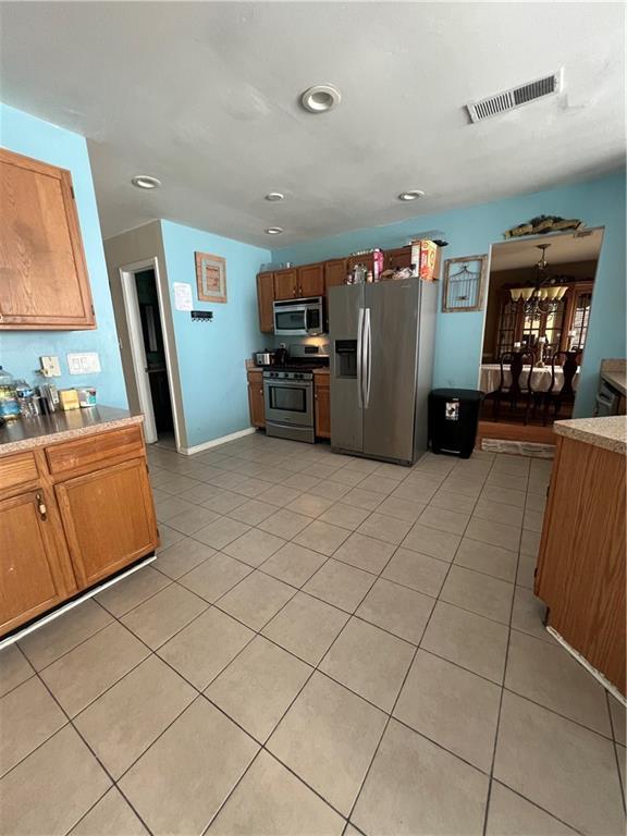 kitchen with stainless steel appliances and light tile patterned floors