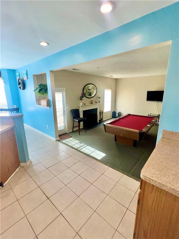 recreation room with a healthy amount of sunlight, light tile patterned floors, and pool table