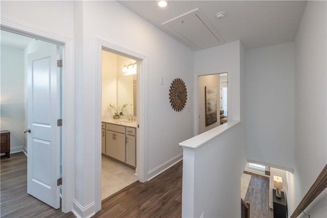 hallway with sink and hardwood / wood-style floors