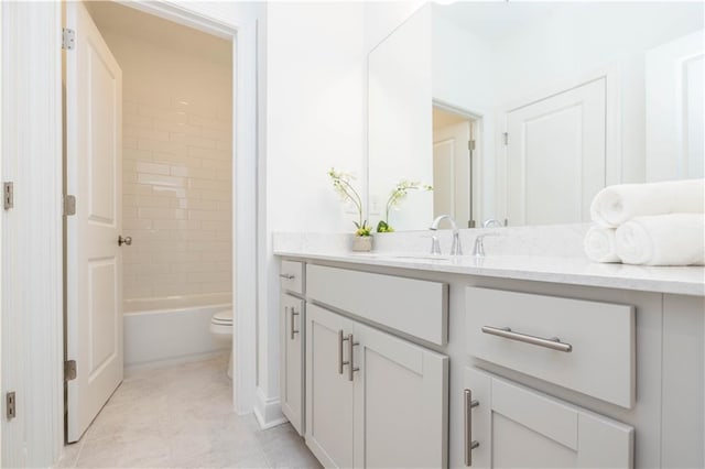 full bathroom featuring vanity, tiled shower / bath, toilet, and tile patterned floors