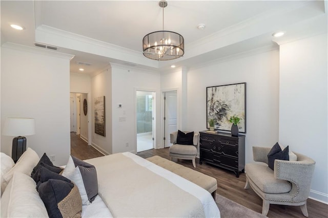 bedroom with visible vents, ornamental molding, and wood finished floors