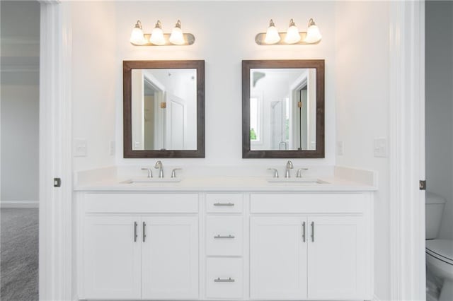 bathroom featuring vanity and toilet