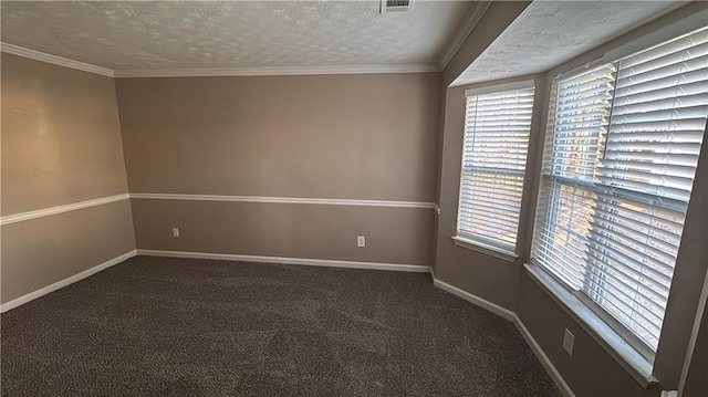 unfurnished room with a textured ceiling, dark colored carpet, and a wealth of natural light