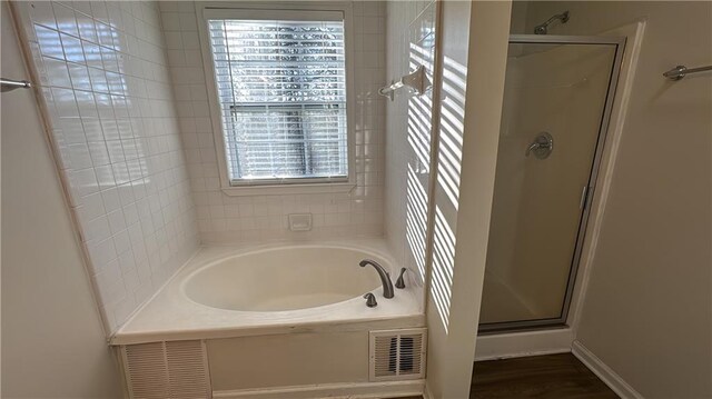 bathroom with separate shower and tub and hardwood / wood-style flooring