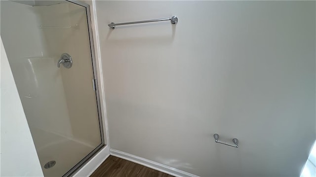 bathroom with walk in shower and hardwood / wood-style flooring