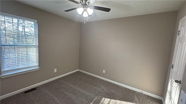 carpeted empty room featuring ceiling fan