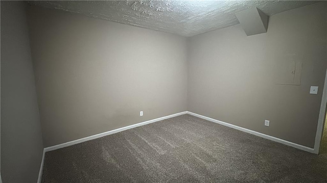 carpeted spare room with a textured ceiling