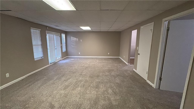 carpeted spare room with a paneled ceiling