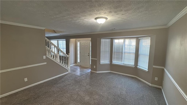 spare room featuring a textured ceiling, crown molding, and a healthy amount of sunlight