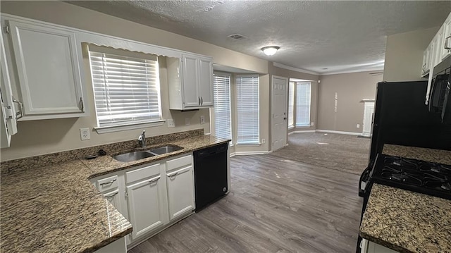 kitchen with black appliances, white cabinets, dark stone countertops, and a textured ceiling