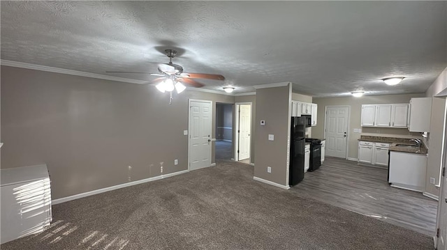 kitchen with a textured ceiling, black appliances, white cabinetry, sink, and ceiling fan