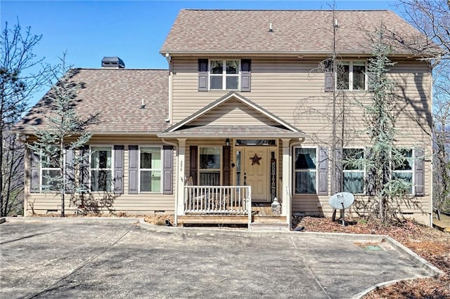 view of front of home with crawl space, covered porch, and a shingled roof