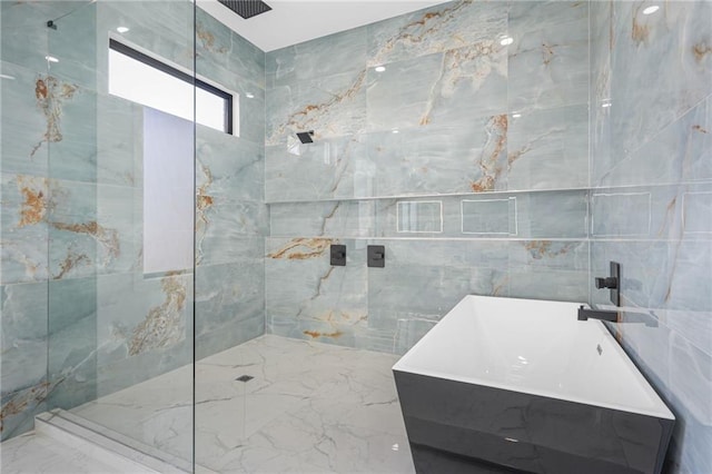 bathroom featuring tile walls, sink, and shower with separate bathtub