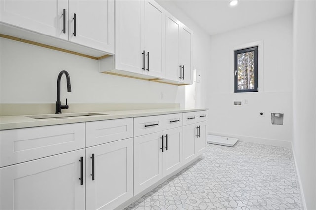 washroom featuring washer hookup, sink, cabinets, and electric dryer hookup