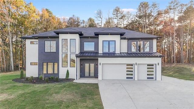 view of front of house with a garage and a front yard