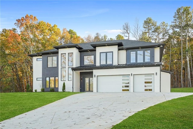 view of front of property featuring a front yard and a garage