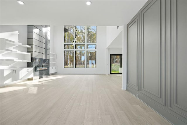 unfurnished living room featuring light wood-type flooring