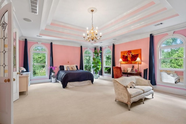 bedroom featuring ornamental molding, a tray ceiling, and multiple windows