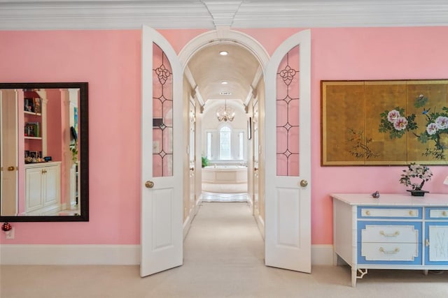 corridor featuring light colored carpet and crown molding