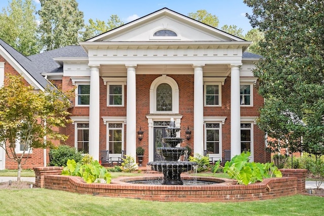 greek revival house with a front yard